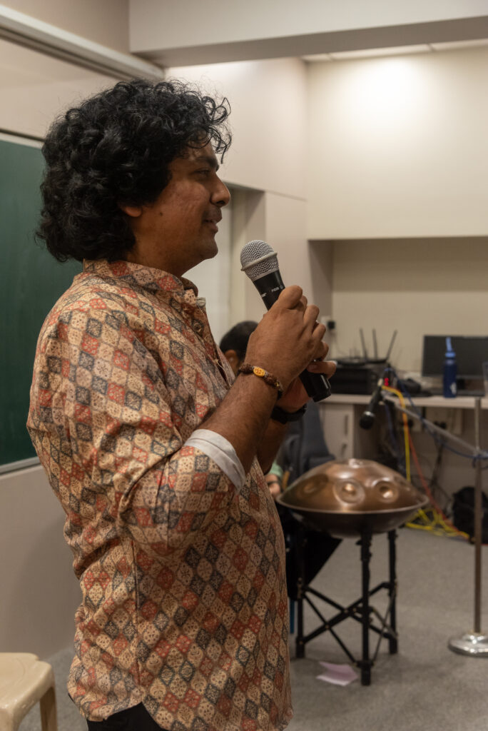 Sanket Nashikkar speaking to the audience before a Handpan Echoes live performance.