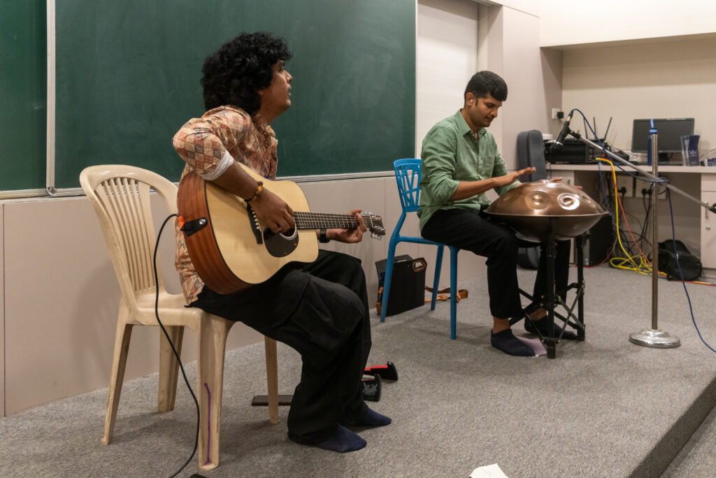 Handpan Echoes performing a live instrumental session featuring handpan and acoustic guitar.