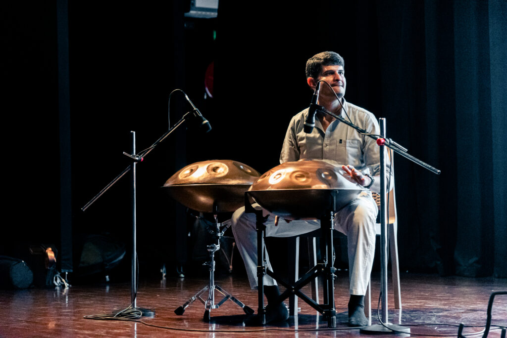 Professional handpan musician performing live during an immersive music experience in Pune.