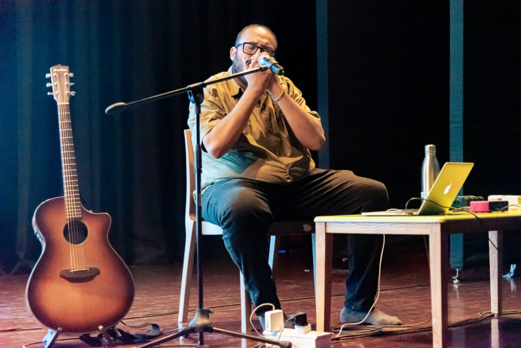 Musician performing harmonica during an immersive live music session in Pune.