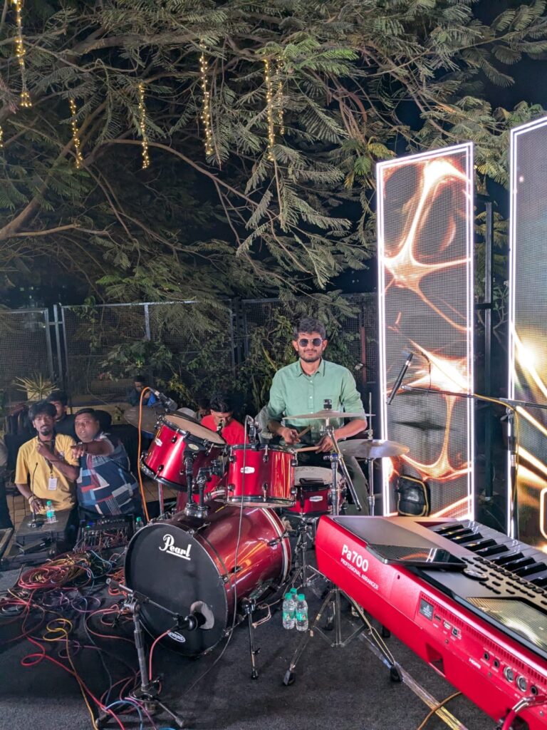 The Rhythm Story performing live with a band during a music event in Pune.