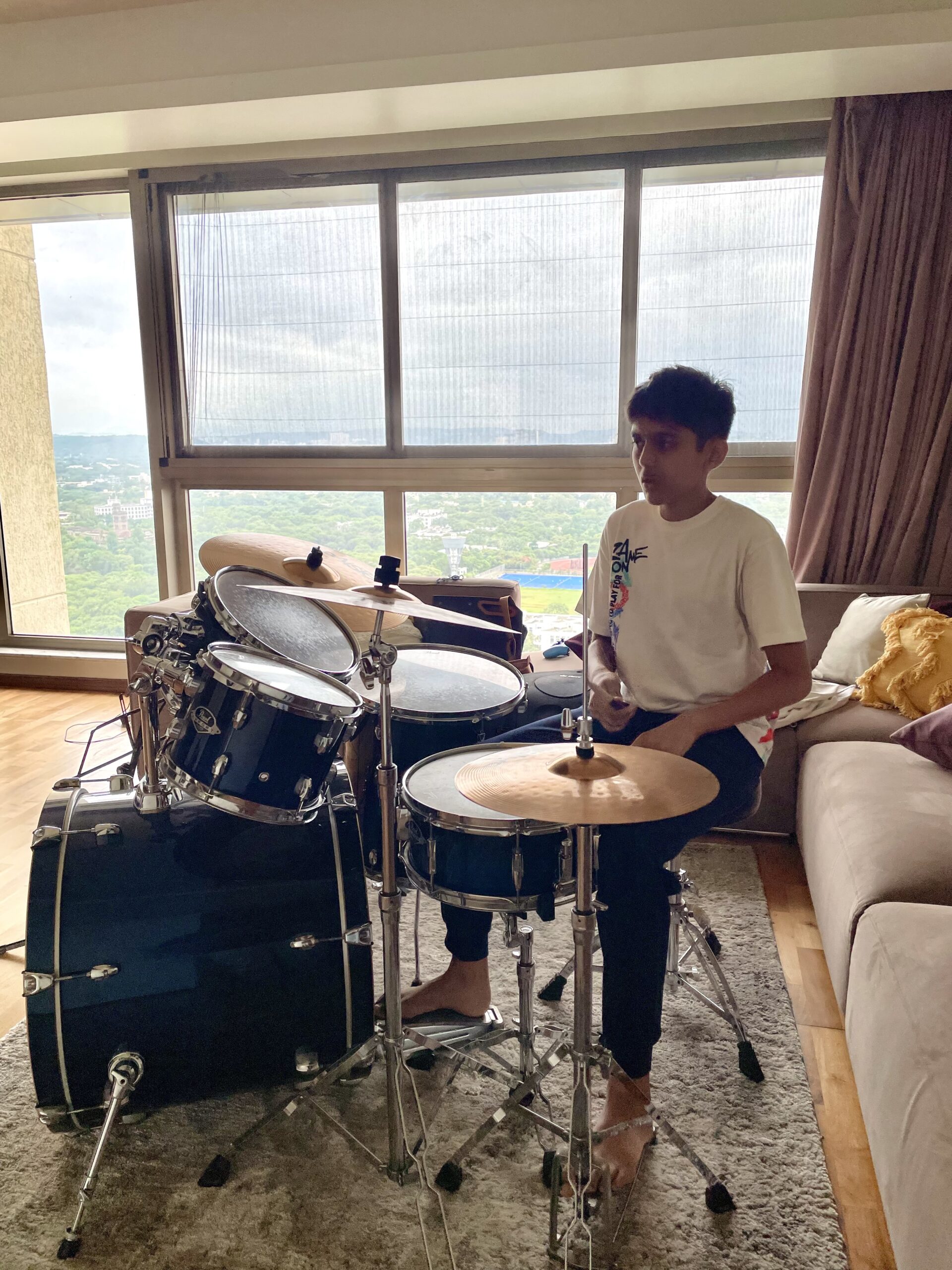 Student learning drums during home tuition in Pune