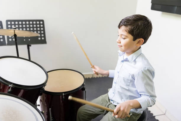 A child appearing for Trinity drums exams in Pune through a home tutor